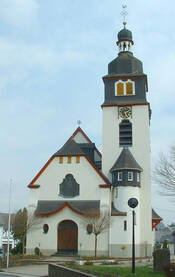 Das Foto zeigt die Front der im Jugendstil errichteten evangelischen Pfarrkirche St. Georg. Neben dem Haupthaus ist der große Kirchturm zu sehen