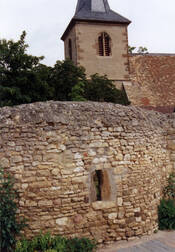 Das Bild zeigt die Kirchmauer und den Kirchturm der katholischen Kirche St.Mauritius